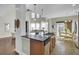 Well-equipped kitchen with island, dishwasher, and view of the high ceiling living area at 314 Foxbank Plantation Blvd, Moncks Corner, SC 29461