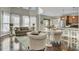 Open-concept living area features hardwood floors, neutral decor, and an adjacent dining space at 314 Foxbank Plantation Blvd, Moncks Corner, SC 29461