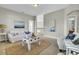 Bright living room boasts neutral colors, a cozy sofa and chair, coastal decor and a decorative coffee table at 314 Foxbank Plantation Blvd, Moncks Corner, SC 29461