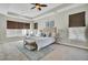 Spacious main bedroom featuring a tray ceiling, a plush bed, and large windows with window treatments at 314 Foxbank Plantation Blvd, Moncks Corner, SC 29461