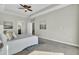 Bright main bedroom with neutral walls, carpet, a tray ceiling, and artwork, next to the bathroom at 314 Foxbank Plantation Blvd, Moncks Corner, SC 29461