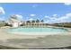 Community pool with a beach entry, pergola, and a fenced playground with seating for relaxation and recreation at 314 Foxbank Plantation Blvd, Moncks Corner, SC 29461