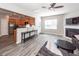 Open-concept living room featuring modern flooring, a ceiling fan, and a cozy fireplace at 317 Cantley Ct, Summerville, SC 29486
