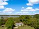 Overhead view of home amidst lush trees with views of waterway in the background at 3398 Freeman Hill Rd, Johns Island, SC 29455