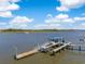 Aerial view of private dock, boat lift, and gazebo on the waterway with lush surrounding marshland at 3398 Freeman Hill Rd, Johns Island, SC 29455