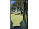 Backyard view through a screen door showing a swing hanging from an oak tree at 3398 Freeman Hill Rd, Johns Island, SC 29455