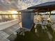 Boat dock featuring a lift with a boat under a covered structure with sunset at 3398 Freeman Hill Rd, Johns Island, SC 29455