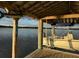 Boat docked on a lift under a covered structure featuring decorative fish at 3398 Freeman Hill Rd, Johns Island, SC 29455