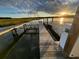 Waterfront home features a private dock with boat lift and stunning sunset views over the water at 3398 Freeman Hill Rd, Johns Island, SC 29455