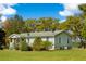 Charming single-story home with a welcoming porch, landscaped yard, and mature trees creating a peaceful setting at 3398 Freeman Hill Rd, Johns Island, SC 29455