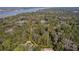 Gorgeous homesite surrounded by lush trees and scenic waterfront views and marked with a yellow boundary line at 3434 Kit Freeman Ln, Johns Island, SC 29455