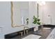 Modern bathroom with double vanity featuring decorative mirrors and black countertops at 3434 Kit Freeman Ln, Johns Island, SC 29455
