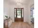 Inviting foyer with wood flooring, paneled walls, and modern light fixture at 3434 Kit Freeman Ln, Johns Island, SC 29455