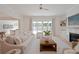 Bright, open living room with comfortable seating and view to the backyard through sliding glass doors at 3434 Kit Freeman Ln, Johns Island, SC 29455