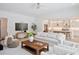 Bright, open-concept living room flowing into a modern kitchen with stainless steel appliances and a large center island at 3434 Kit Freeman Ln, Johns Island, SC 29455