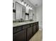 Modern bathroom features double vanity with granite countertop, dark cabinets and decorative lighting at 3676 Shutesbury St, Mount Pleasant, SC 29466