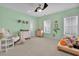 Bright bedroom with green walls features a ceiling fan and two windows for natural light at 3676 Shutesbury St, Mount Pleasant, SC 29466