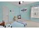 Comfortable bedroom with blue walls and a window offering natural light at 3676 Shutesbury St, Mount Pleasant, SC 29466
