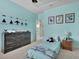 Well-lit bedroom with blue walls and airplane decorations creating an aviation-themed space at 3676 Shutesbury St, Mount Pleasant, SC 29466