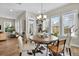 Dining area with a round wood table, six chairs, and an array of windows that let in tons of natural light at 3676 Shutesbury St, Mount Pleasant, SC 29466