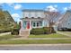 Charming two-story home featuring a red front door, inviting porch, and manicured landscaping on a sunny day at 3676 Shutesbury St, Mount Pleasant, SC 29466