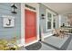 Cozy front porch with a red door, table and chairs, and stylish décor creating a warm welcome at 3676 Shutesbury St, Mount Pleasant, SC 29466
