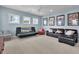 Living room with neutral carpet, blue walls, three windows, and a set of couches with accompanying wall art at 3676 Shutesbury St, Mount Pleasant, SC 29466