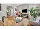 Bright living room featuring hardwood floors, comfortable seating, and large windows offering plenty of natural light at 3676 Shutesbury St, Mount Pleasant, SC 29466