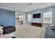 Open living room features a blue barn door, comfortable seating, and large windows for ample natural light at 3676 Shutesbury St, Mount Pleasant, SC 29466