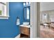 Stylish powder room with blue walls, vessel sink, and modern fixtures adding a touch of elegance at 3676 Shutesbury St, Mount Pleasant, SC 29466