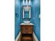 Chic powder room with blue walls, modern sink, and sleek fixtures adding a pop of color at 3676 Shutesbury St, Mount Pleasant, SC 29466