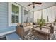 Relaxing screened porch furnished with wicker furniture and decorative curtains at 3676 Shutesbury St, Mount Pleasant, SC 29466