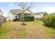 View of the backyard with a screened-in porch and green grass at 406 Butterfly Bush Dr, Goose Creek, SC 29445