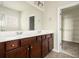 Bathroom features a double sink vanity with dark wood cabinets and a large mirror at 406 Butterfly Bush Dr, Goose Creek, SC 29445