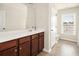 Bathroom featuring a long vanity, a sink, a large mirror, and a window at 406 Butterfly Bush Dr, Goose Creek, SC 29445