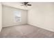 Spacious bedroom with plush carpeting, a ceiling fan, and a window providing natural light at 406 Butterfly Bush Dr, Goose Creek, SC 29445