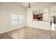 Cozy dining area featuring natural light from large windows. The kitchen is visible through a half wall at 406 Butterfly Bush Dr, Goose Creek, SC 29445