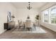 Bright dining room featuring modern chandelier, furniture, and natural light from a large window at 406 Butterfly Bush Dr, Goose Creek, SC 29445