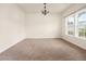Bright dining room featuring natural light from a large window and neutral carpet at 406 Butterfly Bush Dr, Goose Creek, SC 29445