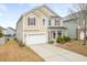 Charming two-story home with a well-maintained yard and attached two-car garage at 406 Butterfly Bush Dr, Goose Creek, SC 29445