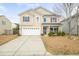 Charming two-story home with a well-maintained front yard and attached two-car garage at 406 Butterfly Bush Dr, Goose Creek, SC 29445