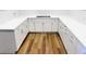 Modern kitchen with white cabinets, light countertops, and stylish hardware at 406 Butterfly Bush Dr, Goose Creek, SC 29445