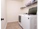Laundry room featuring a washer and dryer, overhead shelving, and linoleum flooring at 406 Butterfly Bush Dr, Goose Creek, SC 29445