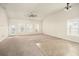 Bright living room features a ceiling fan, neutral paint, and a mix of carpet and vinyl flooring at 406 Butterfly Bush Dr, Goose Creek, SC 29445