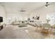 Bright living room features a ceiling fan, neutral paint, and a mix of carpet and vinyl flooring at 406 Butterfly Bush Dr, Goose Creek, SC 29445