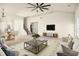 Spacious living room features neutral decor, a ceiling fan, stairs, and an open layout to the dining area at 406 Butterfly Bush Dr, Goose Creek, SC 29445