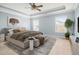 This bedroom features a ceiling fan, tray ceiling, carpeted floor, and modern furniture at 406 Butterfly Bush Dr, Goose Creek, SC 29445