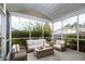 Cozy screened-in porch with comfortable seating, perfect for relaxation and enjoying the outdoors at 406 Butterfly Bush Dr, Goose Creek, SC 29445