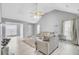 Airy living room with vaulted ceiling, neutral-colored furniture, and hardwood flooring throughout at 4064 Bonaparte Dr, North Charleston, SC 29418