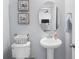 Charming powder room with stylish pedestal sink, decorative artwork, and neutral paint at 464 Fox Sparrow Ct, Summerville, SC 29486